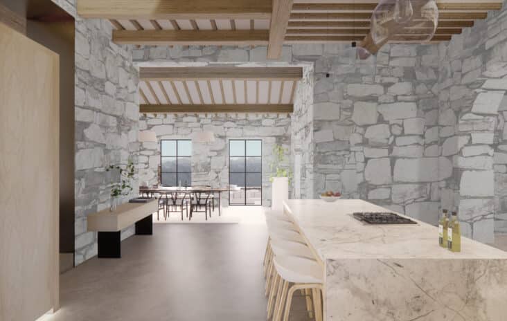 Interior shot of stone walled kitchen in Chianti, Italy with a marble counter top and high chairs to the right